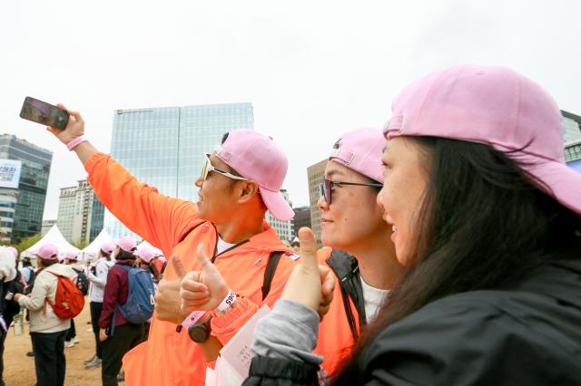 Participants pose for a photo before the start of the Walking Festival for Blue House and Five Royal Palaces in Seoul on Oct 19 2024 AJP Kim Dong-woo