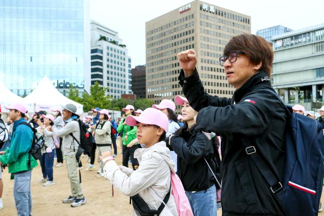 Participants warm up before the start of the Walking Festival for the Blue House and Five Royal Palaces in Seoul on Oct 19 2024 AJP Kim Dong-woo