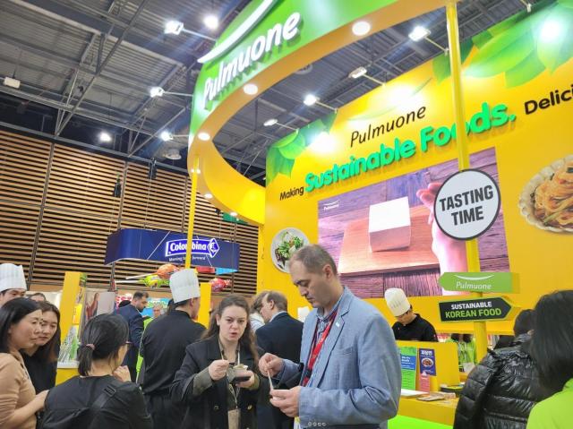 Visitors at the Pulmuone booth in SIAL Paris 2024 taste taste plant-based products Oct 19 2024 Courtesy of Pulmuone