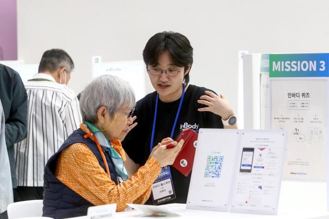 A visitor consults with an exhibitor at the KES 2024 at COEX in Seoul on Oct 22 2024 AJP Kim Dong-woo