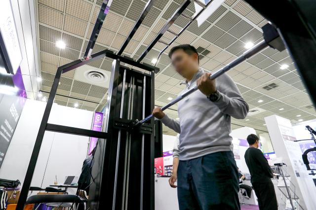 A visitor tries out a device at the KES 2024 at COEX in Seoul on Oct 22 2024 AJP Kim Dong-woo