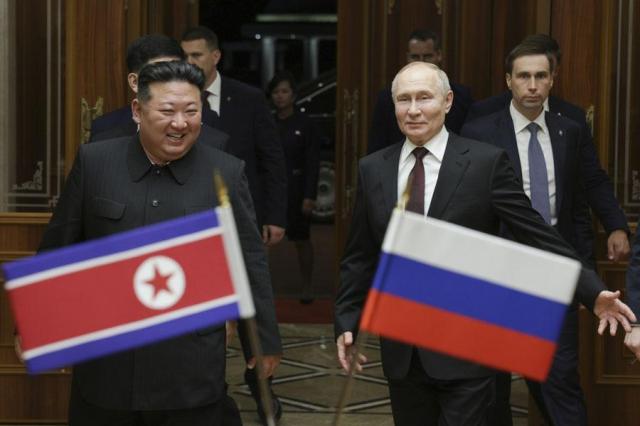 Russian President Vladimir Putin right and North Koreas leader Kim Jong-un smile during their meeting in Pyongyang on June 19 2024 AP-Yonhap