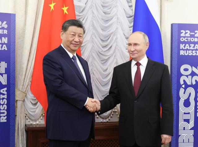 Chinese President Xi Jinping shakes hands with Russian President Vladimir Putin in Kazan Russia Oct 22 2024 Xinhua-Yonhap