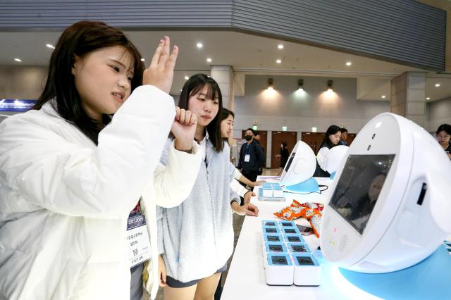 Visitors try out devices at Robot World 2024 at KINTEX in Seoul on Oct 23 2024 AJP Kim Dong-woo