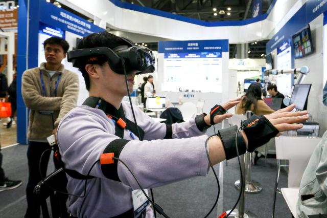 Visitors try out devices at Robot World 2024 at KINTEX in Seoul on Oct 23 2024 AJP Kim Dong-woo