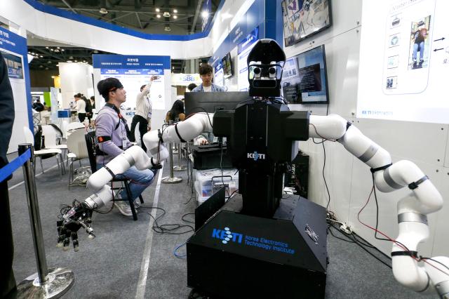 Visitors try out devices at Robot World 2024 at KINTEX in Seoul on Oct 23 2024 AJP Kim Dong-woo