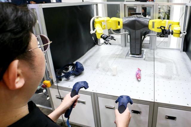 Visitors try out devices at Robot World 2024 at KINTEX in Seoul on Oct 23 2024 AJP Kim Dong-woo