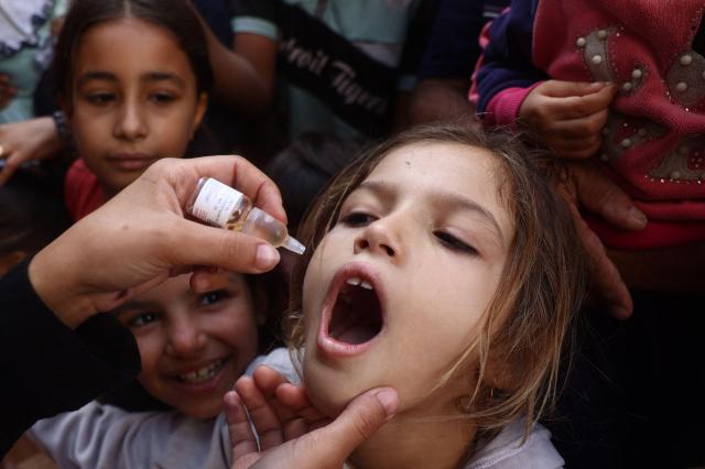 A medic administers a polio vaccine to a Palestinian child in southern Gaza Strip on Oct 19 2024 AFP-Yonhap 