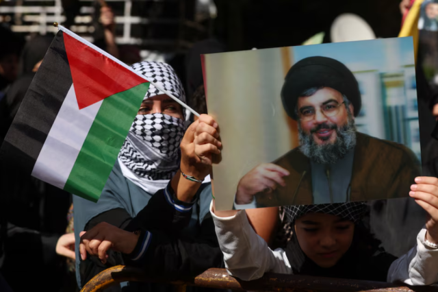 Hezbollah supporters hold flags and banners featuring senior official Sayyed Hashem Safieddine during a protest in Beiruts southern suburbs Lebanon on October 18 2023 REUTERSMohamed AzakirFile Photo