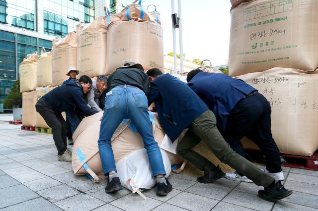 Farmers move fallen rice bags during a rally organized by the National Farmers Federation in Seoul on Oct 24 2024 AJP Kim Dong-woo