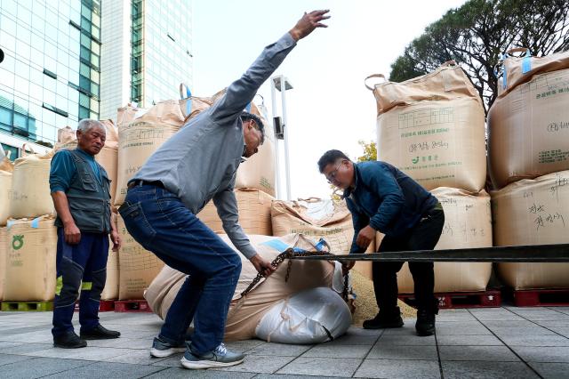 Farmers move fallen rice bags during a rally organized by the National Farmers Federation in Seoul on Oct 24 2024 AJP Kim Dong-woo