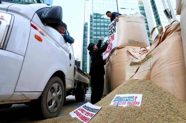 Farmers stack rice during a rally organized by the Korean Peasants League in Seoul on Oct 24 2024 AJP Kim Dong-woo