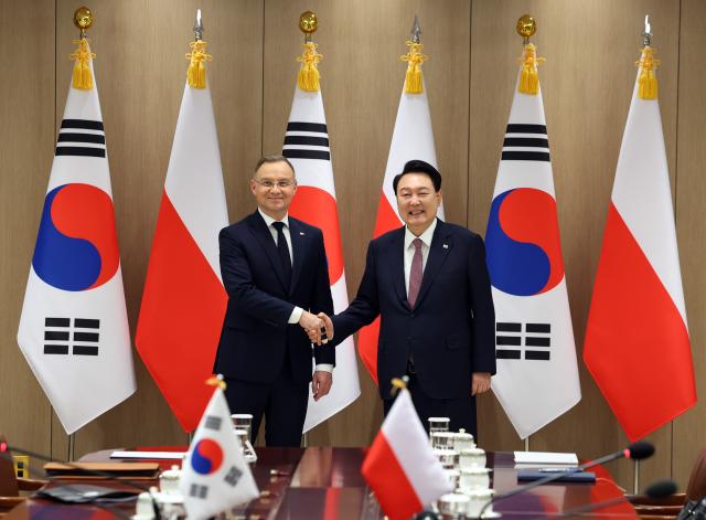 President Yoon Suk Yeol is seen shaking hands with Polish President Andrzej Duda during an expanded South Korea-Poland summit at the presidential office in Yongsan Seoul on Oct 24 Courtesy of the Presidential Office