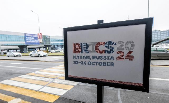 A placard displaying the BRICS summit logo is seen at Kazan Airport Russia on Oct 21 2024 Reuters-Yonhap