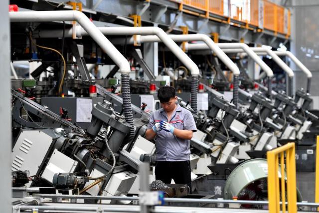 A worker operates in a smart digital workshop at a fastener manufacturing company located in Hebei Province northern China on Aug 16 2024 Xinhua-Yonhap