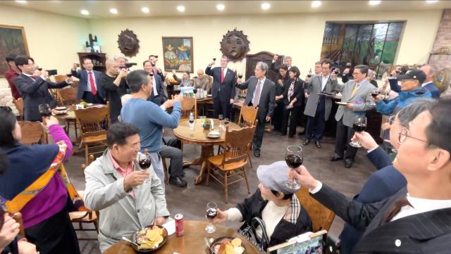 Attendees raise their glasses in a toast at the Latin American Cultural Center in Goyang Gyeonggi Province on October 24 2024