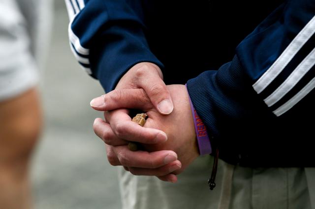 A visitor folds their hands in remembrance at October 29 Memorial Alley in Seoul on Oct 29 2024 AJP Kim Dong-woo