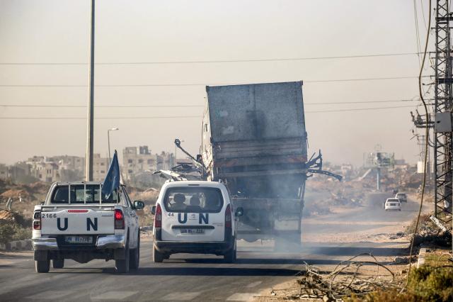 United Nations vehicles escort a damaged truck in central Gaza Strip on Oct 23 2024 AFP-Yonhap