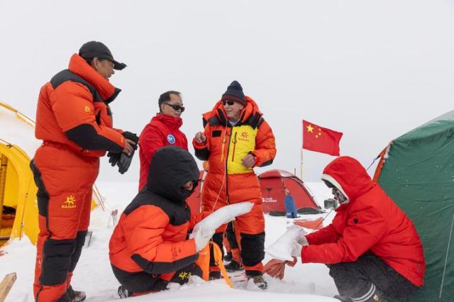 Yao Tandong left back and Lonnie Thompson second from right examine ice cores drilled at a work site on the Purog Kangri Glacier in southwest Chinas Xizang Autonomous Region on Sept 12 2024 Xinhua-Yonhap