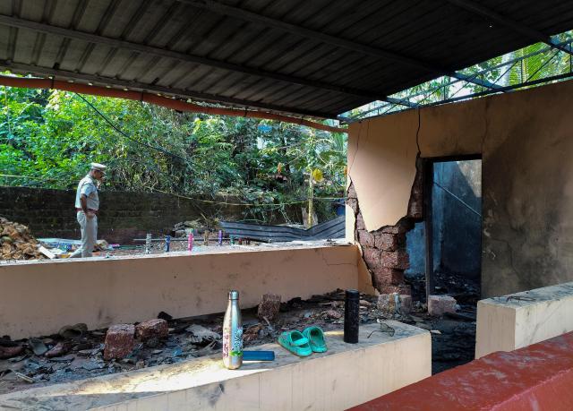 Police investigate the explosion site at a fireworks storage facility of a Hindu temple in Kasaragod Kerala state southern India Oct 29 2024 AP-Yonhap