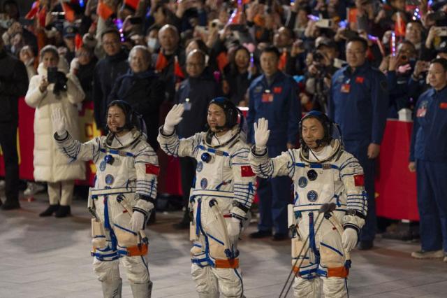 Chinese astronauts Wang Haoze far left Song Lingdong cener and Cai Xuzhe wave during the see-off ceremony for the Shenzhou-19 mission at the Jiuquan Satellite Launch Center in northwestern China Oct 30 2024 AP-Yonhap