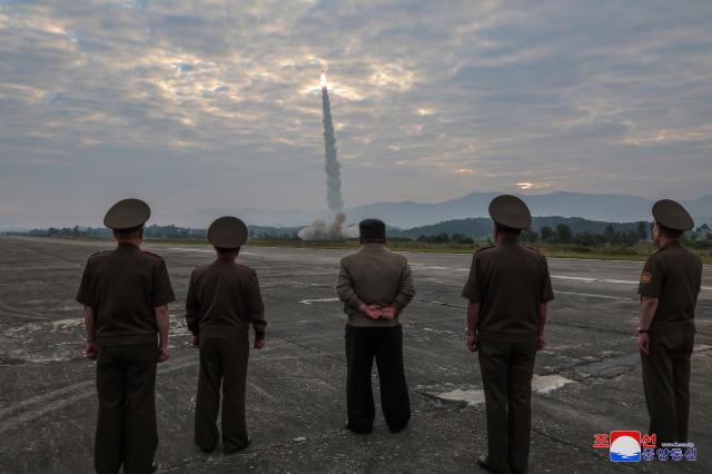 In this file image North Korean Kim Jong-un center inspects a test launch of a Hwasong-11da-45 a ballistic missile with a super-large 45-ton warhead on September 18 KCNA  Yonhap