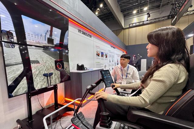 A visitor tries out equipment at the Asia Machinery  Manufacturing Exhibition AMXPO at KINTEX in Goyang Gyeonggi Province on Oct 31 2024 AJP Kim Dong-woo