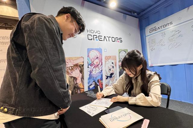 A visitor receives an autograph from a Hoyoverse influencer at Welcome to Hoyoland at KINTEX in Goyang Gyeonggi Province on Oct 31 2024 AJP Kim Dong-woo