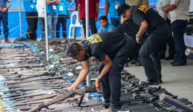 Officials inspect firearms surrendered by Moro Islamic Liberation Front MILF fighters in Maguindanao Mindanao Philippines Sept 7 2019 AFP-Yonhap