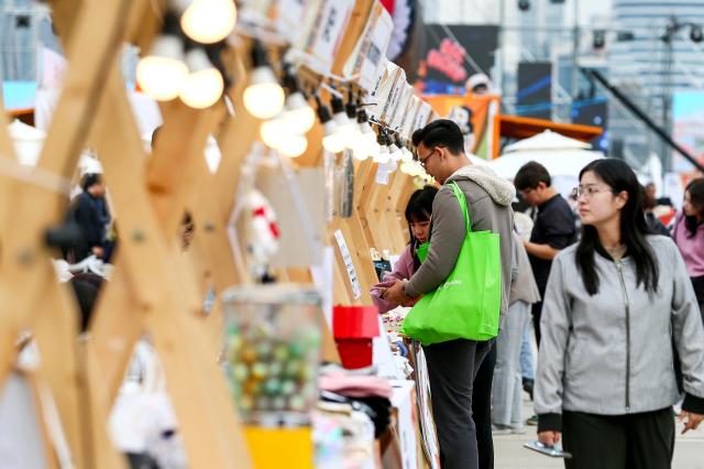 A visitor looks at exhibition booths at the World Gimbap Festival 2024 at Yeouido Hangang Park in Seoul on Nov 1 2024 AJP Kim Dong-woo