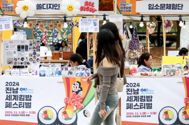 Visitors walk past exhibition booths at the World Gimbap Festival 2024 at Yeouido Hangang Park in Seoul on Nov 1 2024 AJP Kim Dong-woo