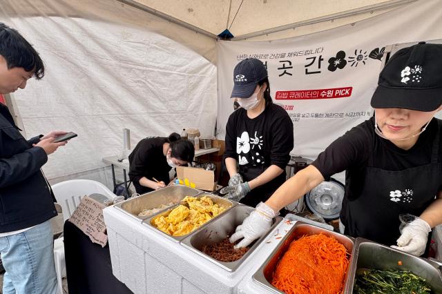 A staff member prepares gimbap at the World Gimbap Festival 2024 at Yeouido Hangang Park in Seoul on Nov 1 2024 AJP Kim Dong-woo