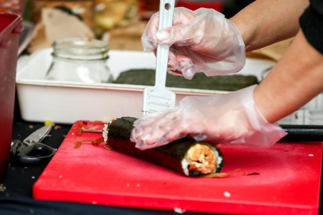 A staff member prepares gimbap at the World Gimbap Festival 2024 at Yeouido Hangang Park in Seoul on Nov 1 2024 AJP Kim Dong-woo