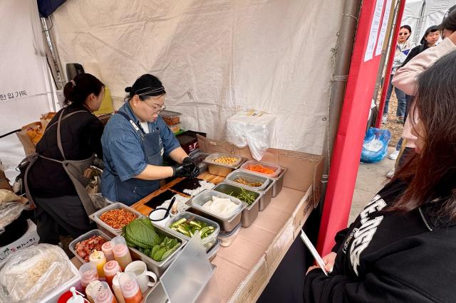 A staff member prepares gimbap at the World Gimbap Festival 2024 at Yeouido Hangang Park in Seoul on Nov 1 2024 AJP Kim Dong-woo