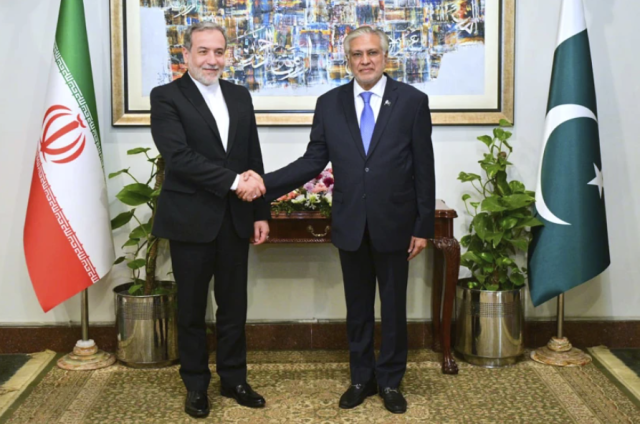 Iranian Foreign Minister Abbas Araghchi left shakes hands with Pakistani Foreign Minister Ishaq Dar ahead of their meeting in Islamabad Pakistan on Nov 5 2024 AP-Yonhap