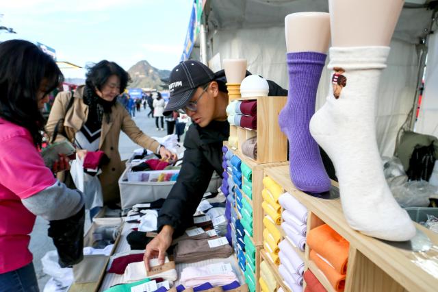 Visitors look at exhibition booths at the 2024 Small Business Day celebration at Gwanghwamun Square in Seoul on Nov 5 2024 AJP Kim Dong-woo