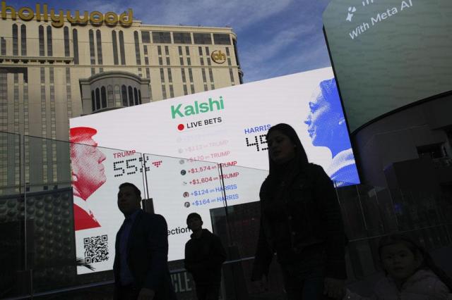 Betting odds on presidential election results are displayed on screens along the Strip in Las Vegas on Nov 5 2024 AP-Yonhap