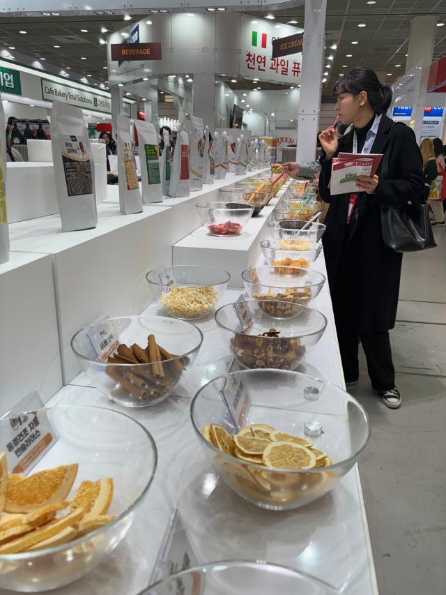 A visitor tastes samples at Cafe Show Seoul at COEX in Seoul on Nov 6 2024 AJP Han Jun-gu