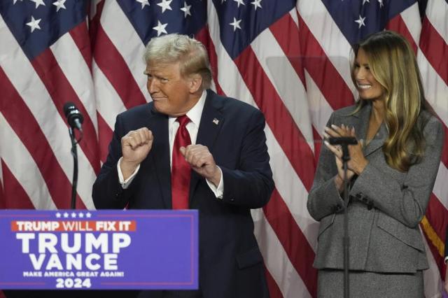 Republican presidential candidate Donald Trump dances as former first lady Melania Trump watches during an election night watch party in West Palm Beach Florida on Nov 6 2024 AP-Yonhap