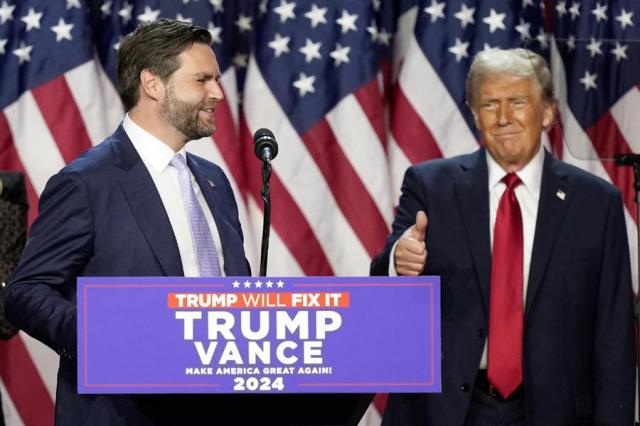 Republican presidential candidate Donald Trump right gives a thumbs-up as vice presidential candidate JD Vance speaks at an election night party in West Palm Beach Florida on Nov 5 2024 AP-Yonhap