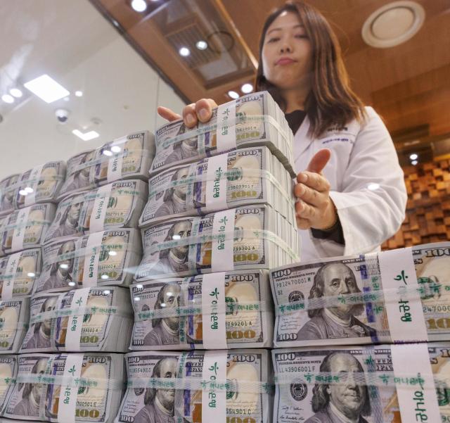 This photo shows an employee stacking dollars at Hana Bank Nov 5 2024 Yonhap