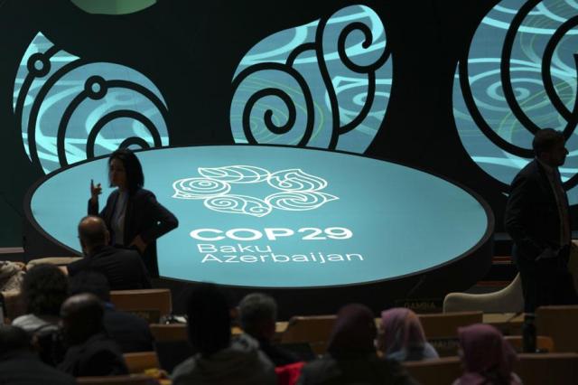 People arrive for an opening plenary session at the COP29 UN Climate Summit in Baku Azerbaijan on Nov 11 2024 AP-Yonhap