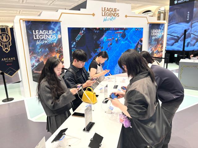 Visitors play Wild Rift the mobile version of League of Legends at the Arcane Season 2 pop-up store in Seoul Nov 11 2024 AJP Han Jun-gu