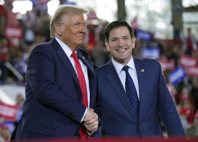 Then-Republican presidential nominee Donald Trump left greets senator Marco Rubio during a campaign rally  in Raleigh North Carolina on Nov 4 2024 AP-Yonhap