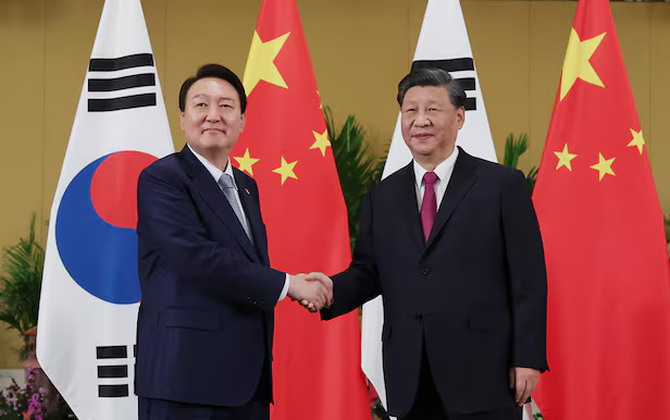 South Korean president Yoon Suk Yeoul and Chinese President Xi Jinping shakes hands at the summit held in Bali Indonesia on Nov 15 2022 Courtesy of Seouls presidential office