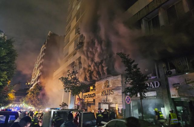 Emergency workers extinguish a fire caused by an Israeli airstrike in Beirut Lebanon on Nov 17 2024 AP-Yonhap