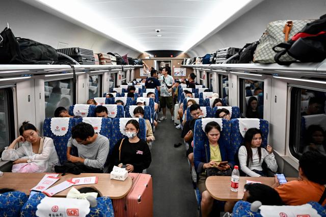 This photo taken on Oct 14 2024 shows passengers sitting on a high-speed train at the railway station in Laos Luang Prabang province AFP-Yonhap