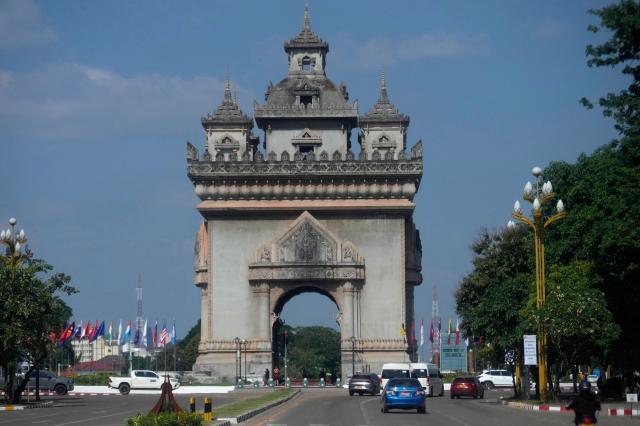 Cars drive in front of the Patuxay victory monument in Vientiane Laos Oct 7 2024 AP-Yonhap