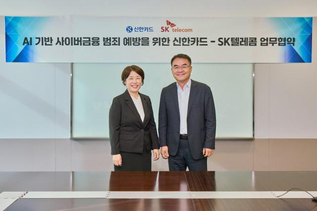  이규식 SKT AI Contact사업 담당사진 오른쪽과 진미경 신한카드 고객 최고 책임자사진 왼쪽가 협약서에 서명하고 기념촬영을 하고 있는 모습