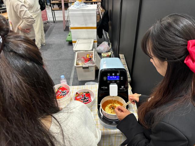 A visitor prepares ramyeon using an automatic cooking machine at the Food Week event at COEX in Seoul Nov 20 2024 AJP Han Jun-gu